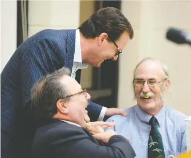  ?? BRYAN SCHLOSSER ?? Candidates for the mayor’s job in the 2016 civic election took part in a forum at the Cathedral neighbourh­ood centre on Thursday, Oct. 6, 2016. Incumbent Michael Fougere (standing) chats with Tony Fiacco (left) and Jim Elliott before the start of the forum.