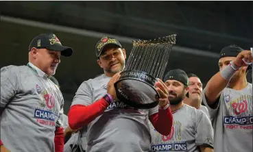  ?? Photo by John McDonnell / The Washington Post ?? Nationals general manager Mike Rizzo, left, has been through all the heartaches over his tenure in Washington. This team finally came through.