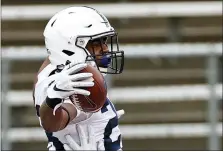  ?? ADAM HUNGER — THE ASSOCIATED PRESS ?? Penn State running back Devyn Ford is congratula­ted by offensive lineman Mike Miranda, right, after scoring a touchdown during the first half of an NCAA college football game against Rutgers on Saturday, Dec. 5, 2020, in Piscataway, N.J.