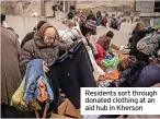  ?? ?? Residents sort through donated clothing at an aid hub in Kherson