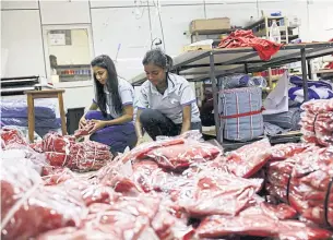  ?? REUTERS ?? Workers package garments at a clothing factory in Colombo. The Internatio­nal Monetary Fund approved a $2.9 billion bailout for Sri Lanka on March 21.