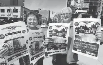  ?? NICK BRANCACCIO ?? Helen Vasilic, left, and Gary Malloy were out on Ouellette Avenue Wednesday to promote the Mission Mile, a onemile run on Ouellette Avenue scheduled for May 19 to raise money for the Downtown Mission.