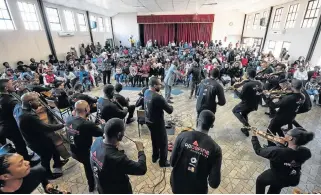  ?? /Graham De Lacy ?? Breaking down barriers: The Buskaid Soweto String Project performs at a community concert in Soweto. It has developed a unique and joyful approach to music making, which motivates the students.