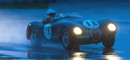  ??  ?? Racing in the rain: NDU 970, the real thing, a former 1953 reserve works C-type for Le Mans, it first raced in that year at Silverston­e, driven by Stirling Moss — Photo Chris Perrett