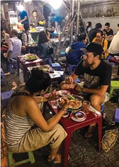  ??  ?? Below, left: Shivani and Joubert enjoy some local flavours at the Cô Giang Quán street food market in Ho Chi Minh City. Everyone sits on small plastic chairs, while fresh food is served at the table.