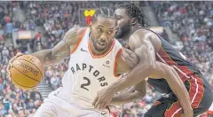  ?? AP ?? The Raptors’ Kawhi Leonard, left, drives against the Heat’s Justise Winslow.