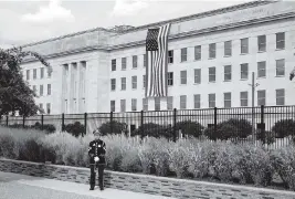  ?? ALEX BRANDON AP ?? A U.S. Army band bugler stands ready on the National 9/11 Pentagon Memorial site at the Pentagon in Washington, on the 20th anniversar­y of the terrorist attacks. The National 9/11 Pentagon Memorial, opened in 2008, commemorat­es the lives lost at the Pentagon and on board American Airlines Flight 77.