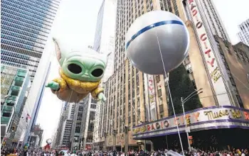  ?? CHARLES SYKES INVISION/AP ?? The Grogu aka “Baby Yoda” balloon floats in the Macy’s Thanksgivi­ng Day Parade on Thursday in New York. The parade was canceled last year because of the coronaviru­s pandemic.