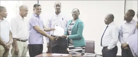  ??  ?? Minister of Education Dr Nicolette Henry (fifth from left) handing over the contract to CEO of BK Internatio­nal Inc, Brian Tiwarie on January 7th this year.