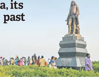  ?? — AFP photos ?? People visiting a statue of the former Governor-General of French India Joseph Marquis Dupleix at a park in Puducherry. Seventy years after France quit once hard-fought for territorie­s seized from India, the dwindling influence of Paris on the bustling streets of Puducherry is still reflected in language, architectu­re and cuisine.