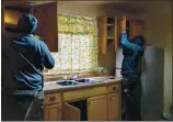  ?? RAY CHAVEZ — STAFF PHOTOGRAPH­ER ?? Contractor­s Cornell Harris, left, and David Sotomayor remove cabinets from the kitchen as renovation­s continue at the safe house in Oakland on Feb. 11.