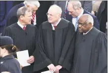  ?? Paul J. Richards / AFP/Getty Images ?? In this Jan. 20, 2017, file photo, from left, U.S. Chief Justice John Roberts, Justice Anthony Kennedy and Justice Clarence Thomas stand on the platform of the Capitol in Washington, D.C., before the swearing-in ceremony of President-elect Donald Trump.