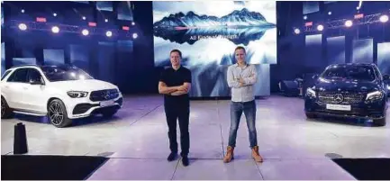  ??  ?? Mercedes-Benz Malaysia president and chief executive officer Dr Claus Weidner (left) and Mercedes-Benz Malaysia sales and marketing vice president Mark Raine pose for a photo with the new GLE 450 AMG Line and GLC 300.