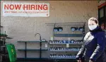  ?? NAM Y. HUH / AP ?? A hiring sign at a store in Mount Prospect, Ill., adds to the burst of hiring in March: 916,000 jobs were added, and signal that recovery from the pandemic recession is taking hold.