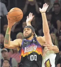  ?? MICHAEL CHOW/THE REPUBLIC ?? Suns center JaVale McGee drives while defended by Pelicans forward Larry Nance Jr. during Game 5 of their playoff series on Tuesday night in Phoenix.