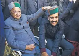  ?? DEEPAK SANSTA/HT ?? Outgoing chief minister Virbhadra Singh with his son Vikramadit­ya, who won from Shimla Rural, at their residence, Holly Lodge, in Shimla on Monday.