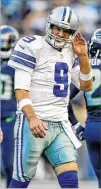  ?? GETTY IMAGES ?? Tony Romo walks off after being tackled and grabbing his back early in Thursday’s game. Coach Jason Garrett held Romo out the rest of the way.