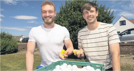  ??  ?? Having a ball Pals Campbell Mathieson and Andrew Bogle have made a real go of their golf ball business
