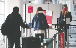  ?? PIERRE OBENDRAUF FILES ?? Passengers get their temperatur­es taken by overhead camera as they enter the main terminal at Trudeau airport in November. The province wants stepped up airport screening for COVID.