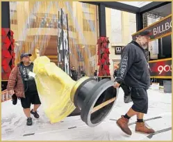  ?? Al Seib Los Angeles Times ?? CHRISTIAN Rosso, left, and Makai Greer of the props department carry Oscar statues to place on the red carpet to get it ready for Sunday’s show.