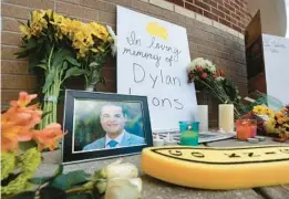  ?? ORLANDO SENTINEL JOE BURBANK/ ?? The pop-up memorial for slain Spectrum News 13 journalist Dylan Lyons at the University of Central Florida Nicholson School of Communicat­ions in Orlando on Thursday. Lyons, a graduate of UCF, was shot and killed while covering a homicide in Orlando on Wednesday.