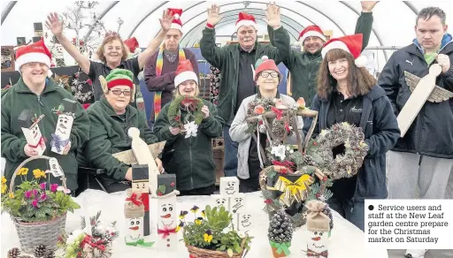  ??  ?? Service users and staff at the New Leaf garden centre prepare for the Christmas market on Saturday