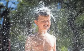  ?? PATRICK BREEN/THE REPUBLIC ?? Chase Carlisle plays in the summer heat at the splash pad at Desert Breeze Park in Chandler.