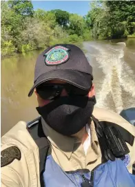  ?? Submitted photo ?? ■ A Texas game warden wears a Mayo reusable mask as he patrols a state waterway.