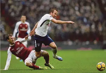  ?? AFP PIC ?? Arsenal’s Nacho Monreal (left) tackles Tottenham Hotspur’s Harry Kane in their Premier League match at Wembley yesterday.