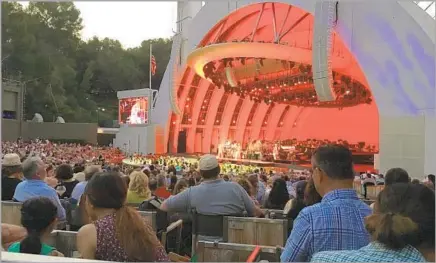  ?? Chris Erskine Los Angeles Times ?? AT THE HOLLYWOOD BOWL they have these boxes where they squeeze four canvas chairs in a space really meant for two.