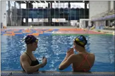  ?? THIBAULT CAMUS — THE ASSOCIATED PRESS ?? Ukrainian sisters Maryna, left, and Vladyslava Aleksiiva speak during a practice session, in Kyiv, Ukraine, on Feb. 21.