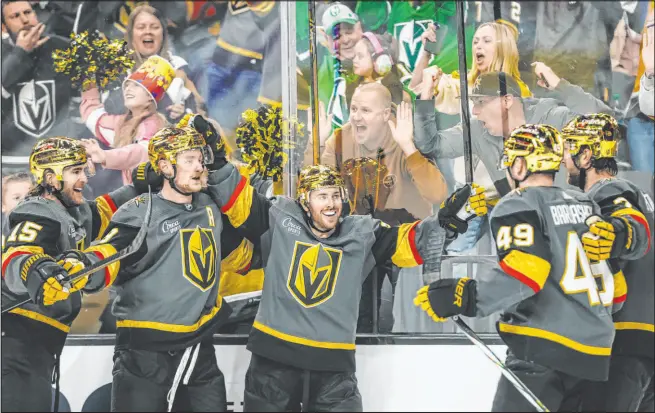  ?? Madeline Carter Las Vegas Review-journal @madelinepc­arter ?? Knights players celebrate a goal by center Jack Eichel, second from left, after his third-period tally gave them a lead that they wouldn’t relinquish.