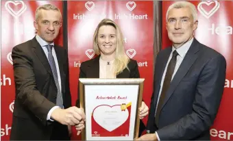  ??  ?? Bridgette Kelly from Teck Ireland, Wicklow, receiving the Gold Active@Work award from Prof Donal O’Shea, Clinical Lead for Obesity at the HSE, and Tim Collins, CEO of the Irish Heart Foundation.