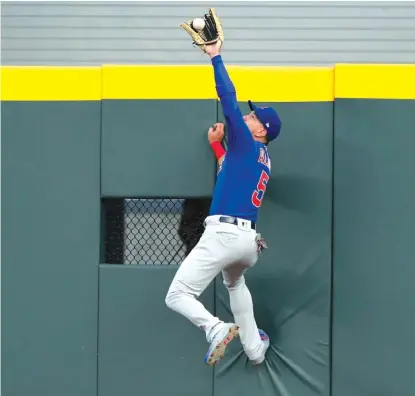  ?? AP ?? Cubs center fielder Albert Almora Jr. robs the Braves’ Tyler Flowers of a home run in the second inning Wednesday in Atlanta.