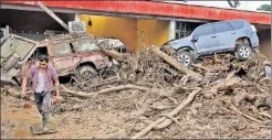  ??  ?? THIS WAS A TOWN: A man slogs through the muck among the ruins of buildings and fallen trees in Mocoa, Colombia, Sunday.