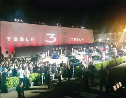  ?? PETER HOLLEY/THE WASHINGTON POST ?? Tesla Model 3 owners await their cars in Freemont, California, on Friday.