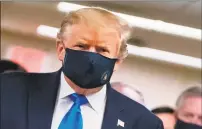  ?? Alex Edelman / AFP via Getty Images ?? President Donald Trump wears a mask for the first time publicly as he visits Walter Reed National Military Medical Center in Bethesda, Maryland Saturday.