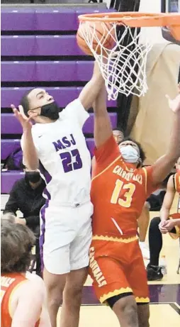  ?? AMY DAVIS/BALTIMORE SUN ?? Mount Saint Joseph’s Bryson Tucker shoots above Calvert Hall’s Karim Harris during a game Wednesday night. The Gaels won 62-56 in Irvington.