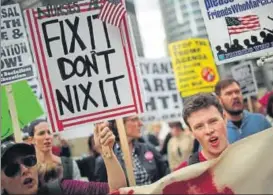  ?? AFP ?? Demonstrat­ors gather near Trump Tower to celebrate the defeat of President Donald Trump's revision of the Affordable Care Act in Chicago, Illinois on Friday .