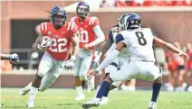  ?? MATT ?? Mississipp­i Rebels running back Scottie Phillips runs the ball while he is defended by Kent State Golden Flashes safety Elvis Hines at Vaught-Hemingway Stadium. BUSH/USA TODAY SPORTS