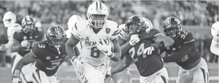  ?? L.G. PATTERSON/AP ?? Memphis running back Patrick Taylor Jr. scrambles past Missouri defenders for a touchdown during the second half of an NCAA college football game Saturday, Oct. 20, 2018, in Columbia, Mo. Missouri won the game 65-33.