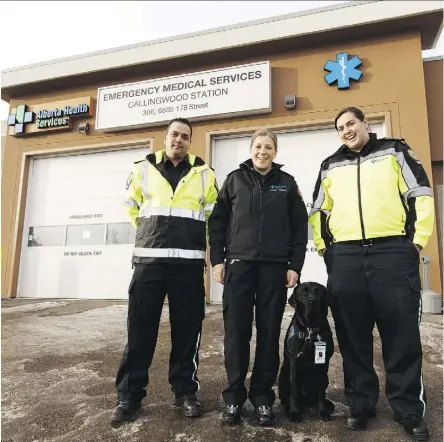  ?? IAN KUCERAK/FILES ?? Advanced care paramedics Matthew Lockert, left, and Erica Olson, with primary care paramedic Amy-Jean Easton stand with therapy dog Delray at the Callingwoo­d EMS Station in December. Associate health minister Brandy Payne said Tuesday 10 more community...