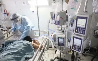  ?? EPA-EFE ?? A HEALTH worker treats a patient infected with the coronaviru­s in Mexico City, Mexico. The writer argues that before making decisions on a nationwide lockdown, the government should have done separate risk assessment­s for each at-risk group. |