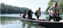  ?? — SUZANNE MORPHET ?? T’aashi Paddle guests arrive at Meares Island in a dugout canoe.