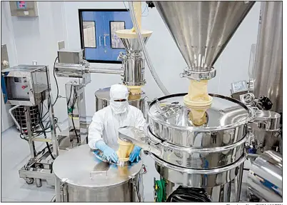  ?? Bloomberg News/SARA HYLTON ?? An employee operates a filtration machine inside a laboratory at a Laurus Labs Ltd. pharmaceut­ical plant in Visakhapat­nam, Andhra Pradesh, India. The factory is preparing to churn out billions of generic pills for HIV patients.