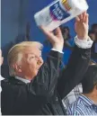  ??  ?? HELPING HAND: Donald Trump tosses supplies in Puerto Rico.