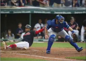  ?? PHIL LONG — THE ASSOCIATED PRESS ?? The Indians’ Francisco Lindor slides into home ahead of the tag from Royals catcher Drew Butera on Sept. 16 at Progressiv­e Field.