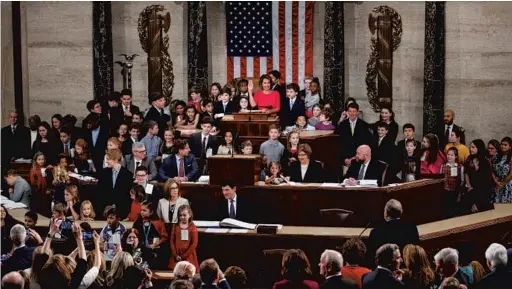  ?? CAROLYN KASTER/AP ?? Nancy Pelosi, surrounded by her grandkids and kids related to lawmakers, raises her hand as Rep. Don Young, R-Alaska, administer­s the oath to become the speaker of the House.