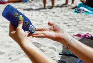  ?? Clara Margais / Getty Images ?? Liberal use of sunscreen is recommende­d when working or playing outside. The CARES Act appears to block an FDA effort for more informatio­n on the products’ safety and effectiven­ess.