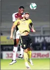  ?? (AP) ?? Aston Villa’s Kortney Hause (left), and Burton Albion’s Kane Hemmings challenge for the ball during the English League Cup soccer match between Burton Albion and Aston Villa at Pirelli Stadium in Bur
ton, England on Sept 15.